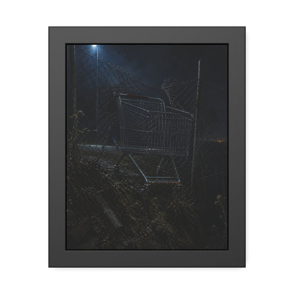 A shopping cart wedged in a chain link fence under a streetlamp. The Abandonment at the Ravine Fence by Garabaggio, framed fine art print, 11″ x 14″.