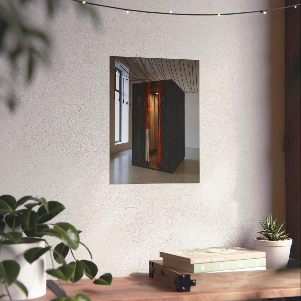 Booth walled with hanging power cords in a bare daylit room. Confessional for Current by Garabaggio, fine art print hanging in a room.