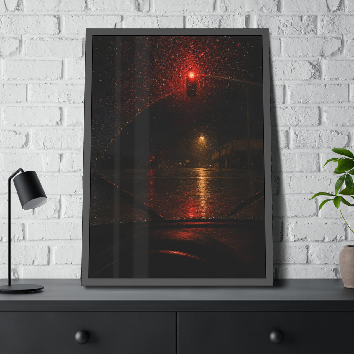 A red traffic light seen through a rain beaded windshield at night. The Windshield at the Red Light by Garabaggio, framed fine art print hanging in a room.