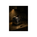 Scorched toaster with burnt toast on a counter under a cabinet light. Breakfast Interrupted by Garabaggio, fine art print, 12″ x 16″.