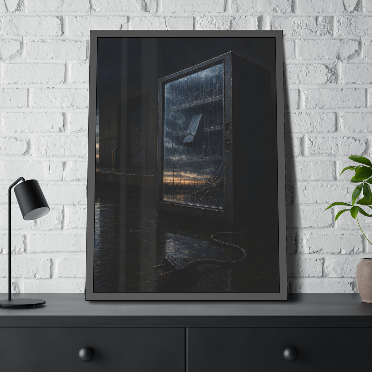 Empty vending machine with cracked glass reflecting dawn on a wet lot. Dawn in the Dead Glass by Garabaggio, framed fine art print hanging in a room.