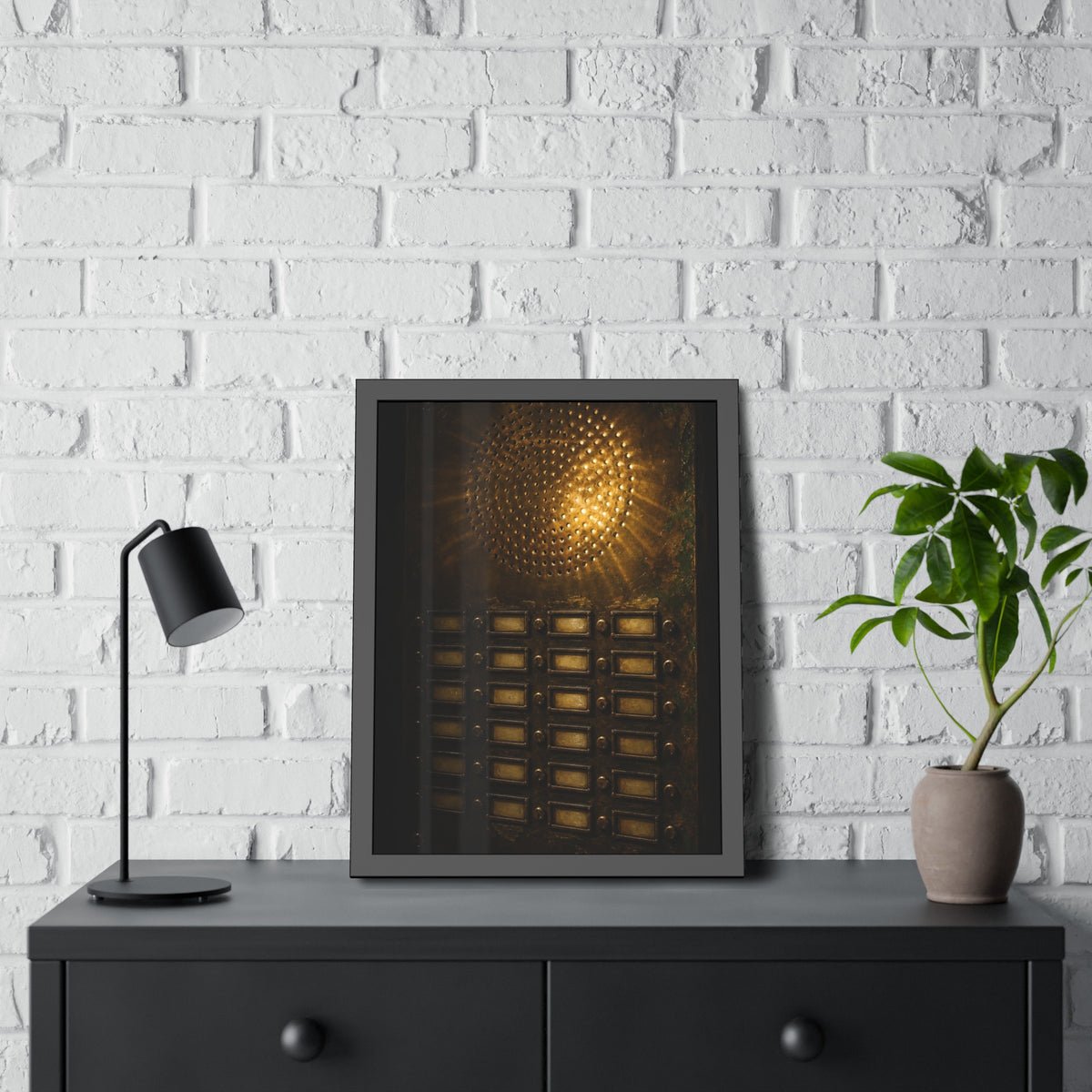 Light glowing through an intercom speaker grille above rows of buttons. Voice Through Perforations by Garabaggio, framed fine art print hanging in a room.