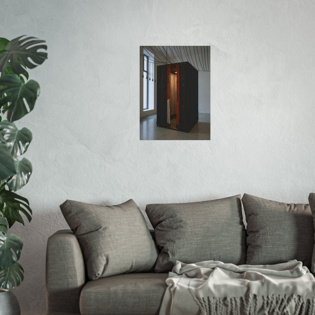 Booth walled with hanging power cords in a bare daylit room. Confessional for Current by Garabaggio, fine art print hanging in a room.