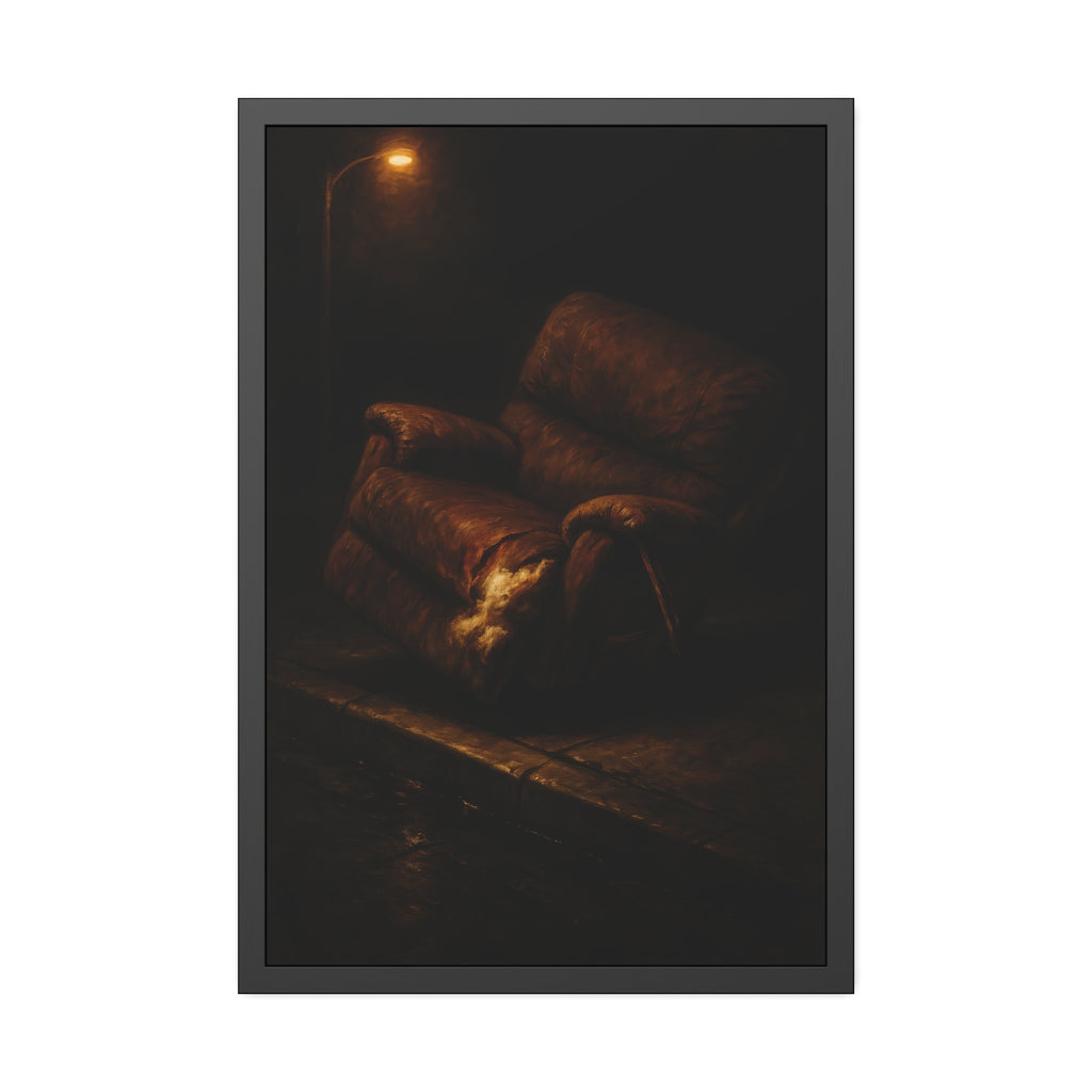 A torn brown recliner tipped on a curb in dim warm light. The Deposition of the Broken Recliner by Garabaggio, framed fine art print hanging in a room.