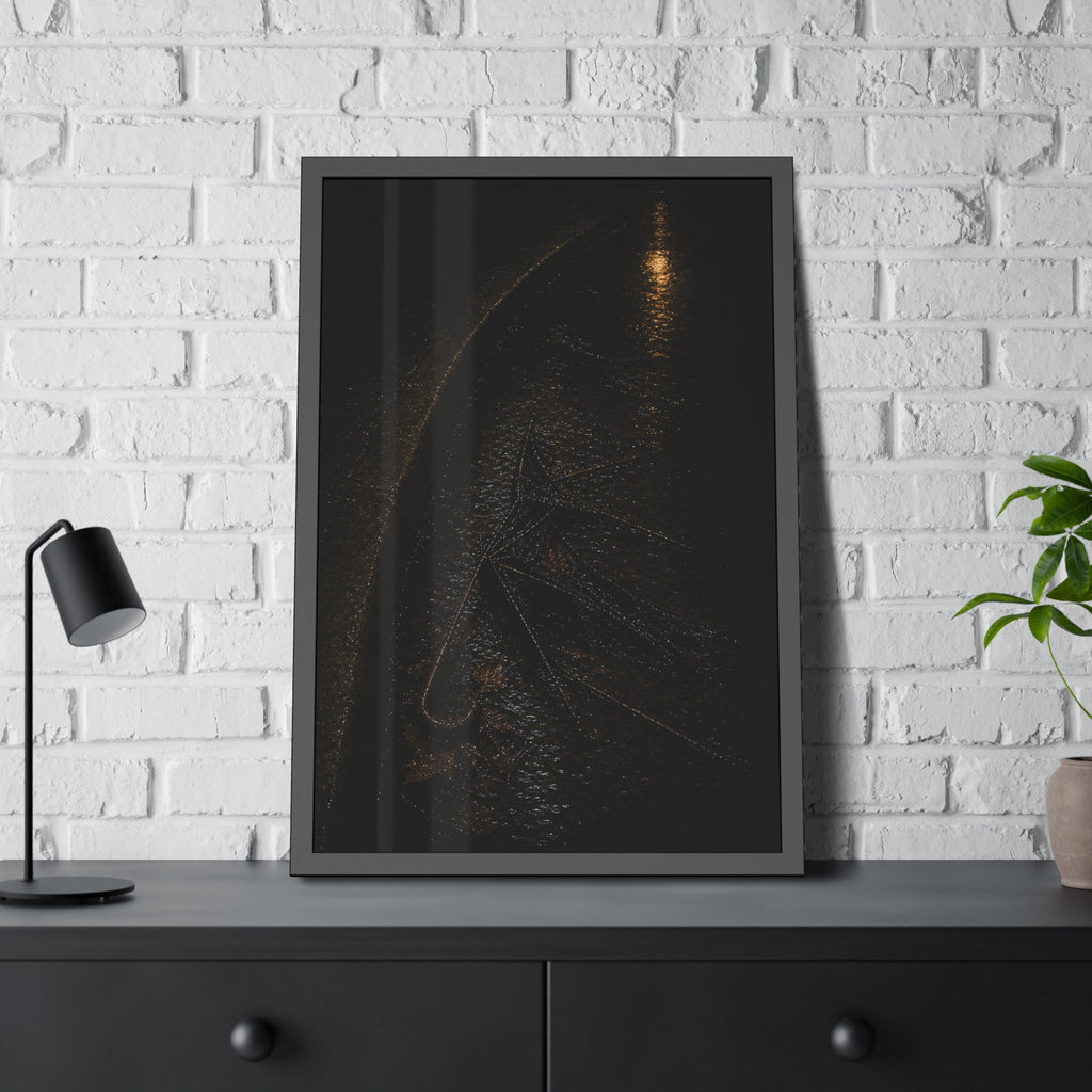 A collapsed umbrella in a dark wet gutter beside a curb, one distant light. The Procession in the Gutter by Garabaggio, framed fine art print hanging in a room.