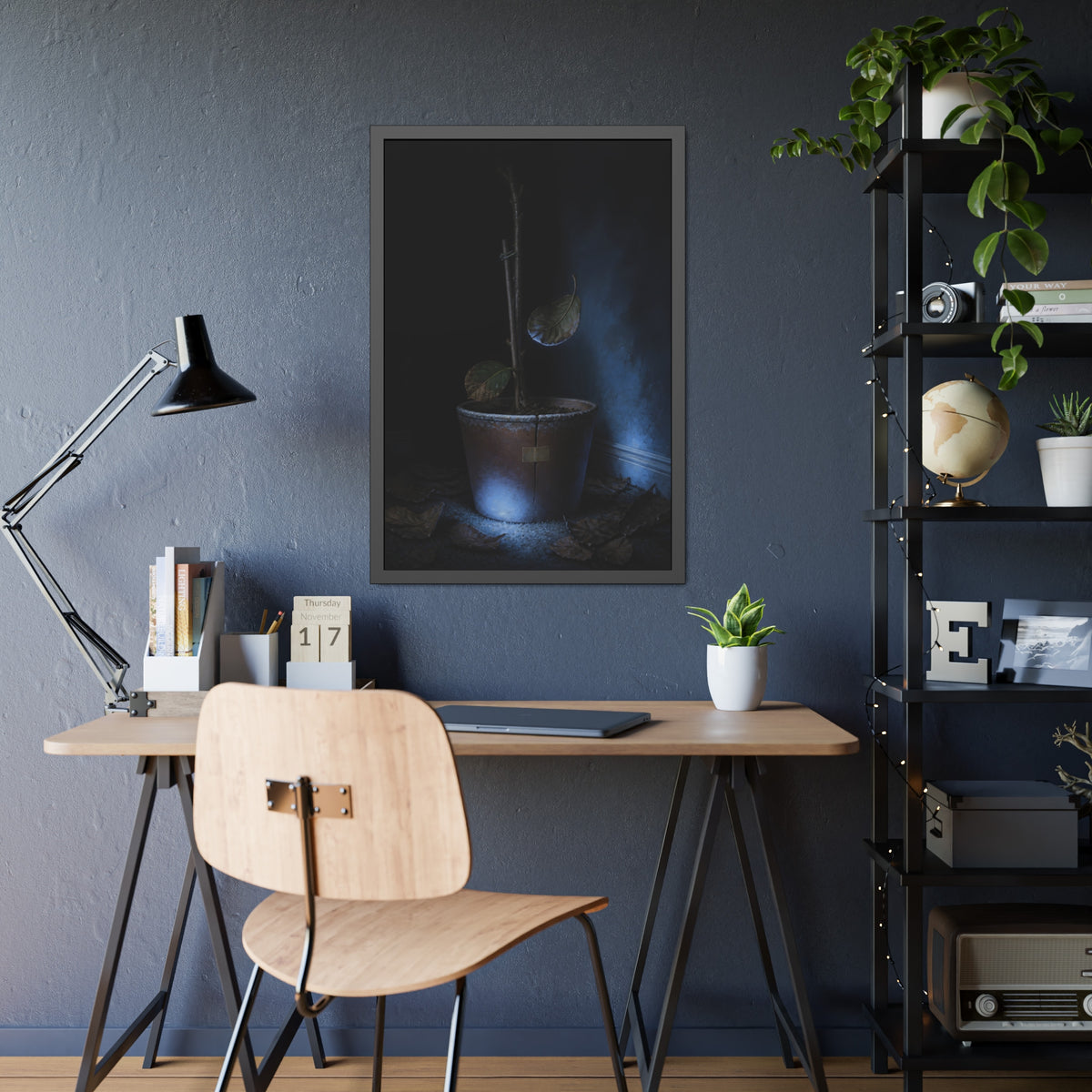 A bare potted plant dropping a leaf, dead leaves on the floor. The Leaf Lets Go by Garabaggio, framed fine art print hanging in a room.