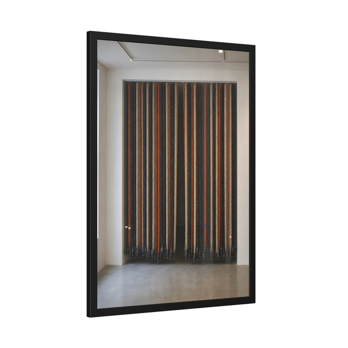 Hundreds of extension cords hung floor to ceiling across a bright white room. The Cord Curtain by Garabaggio, framed fine art print hanging in a room.