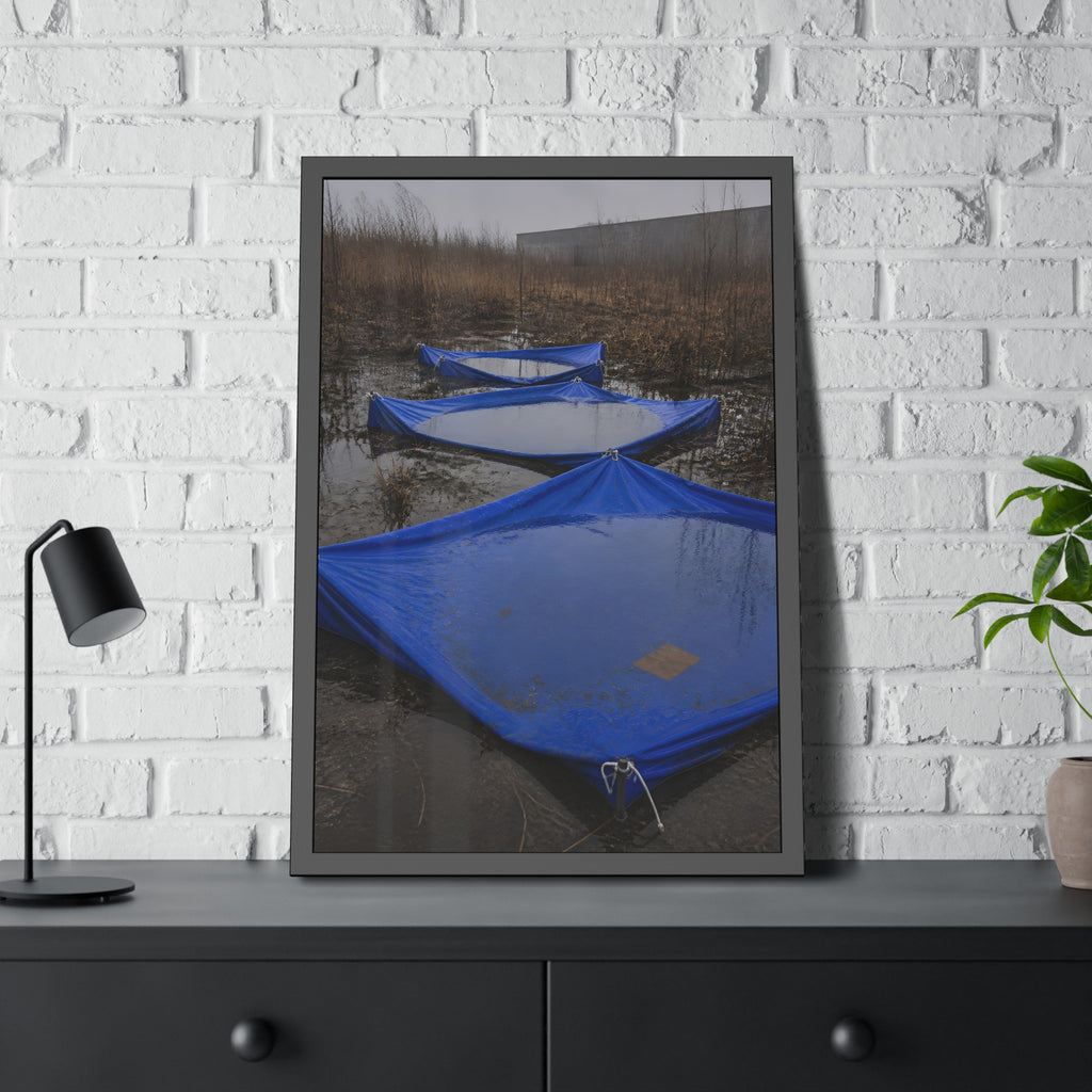 Three blue tarps holding pooled rainwater in a weedy vacant lot. Flooded in the Vacant Lot by Garabaggio, framed fine art print hanging in a room.