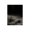 A broken laundry basket half buried in a snowbank under a distant light. Lattice in the Snowbank by Garabaggio, fine art print, 12″ x 16″.