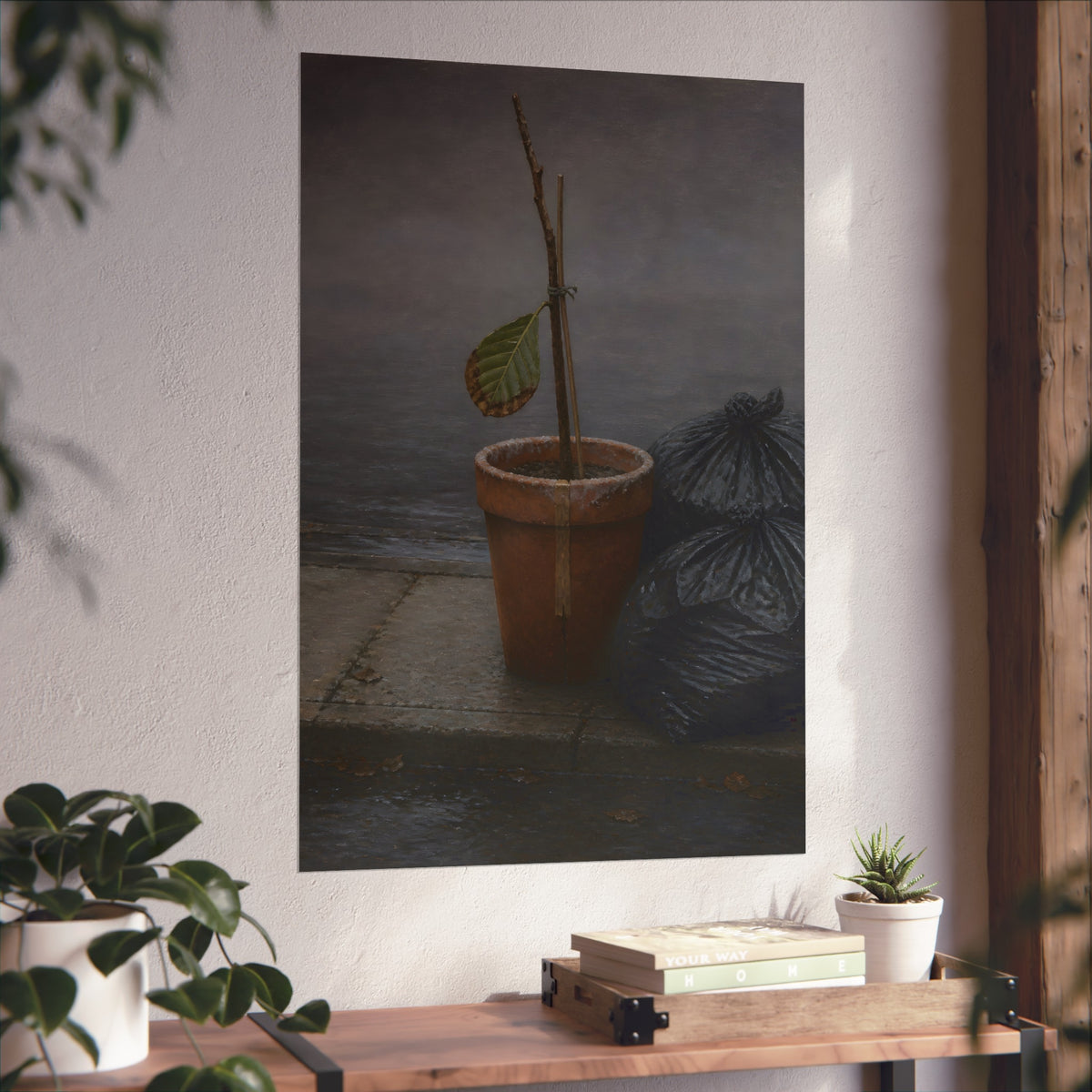 A potted dead twig with one leaf beside black garbage bags on a wet curb. The Curb on Tuesday by Garabaggio, fine art print hanging in a room.