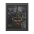 A taped clay pot with one leaf and a green shoot on wet pavement. The Green at the Base by Garabaggio, framed fine art print, 11″ x 14″.