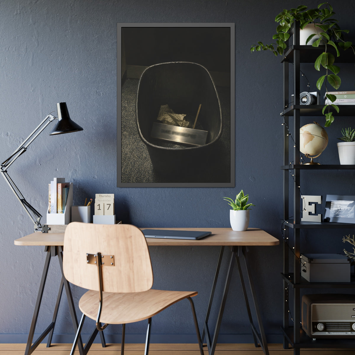A metal nameplate lying in a black office waste bin on grey carpet. The Nameplate in the Waste Bin by Garabaggio, framed fine art print hanging in a room.
