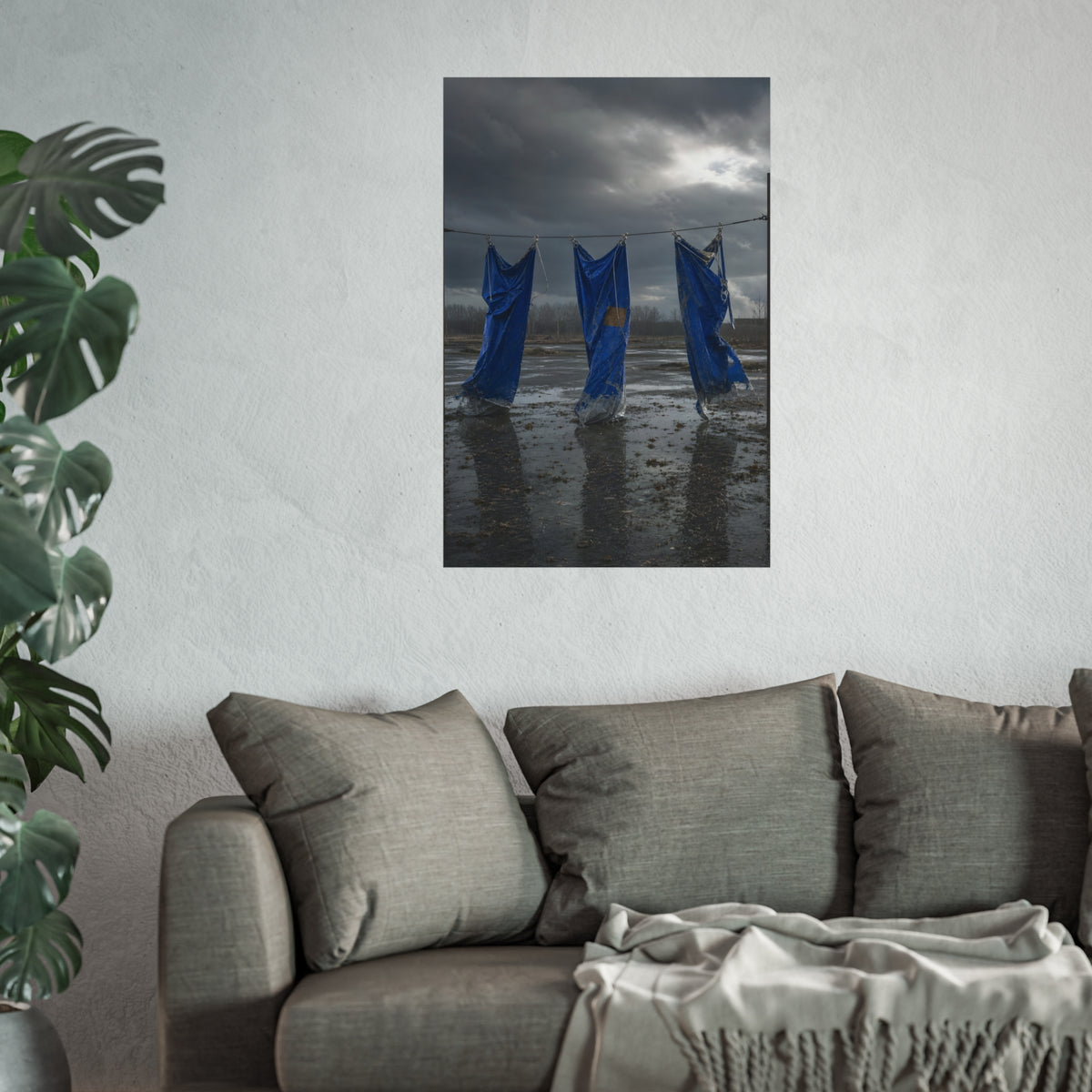 Three blue tarps hung from a wire over a wet lot under storm clouds. Banners After the Gale by Garabaggio, fine art print hanging in a room.