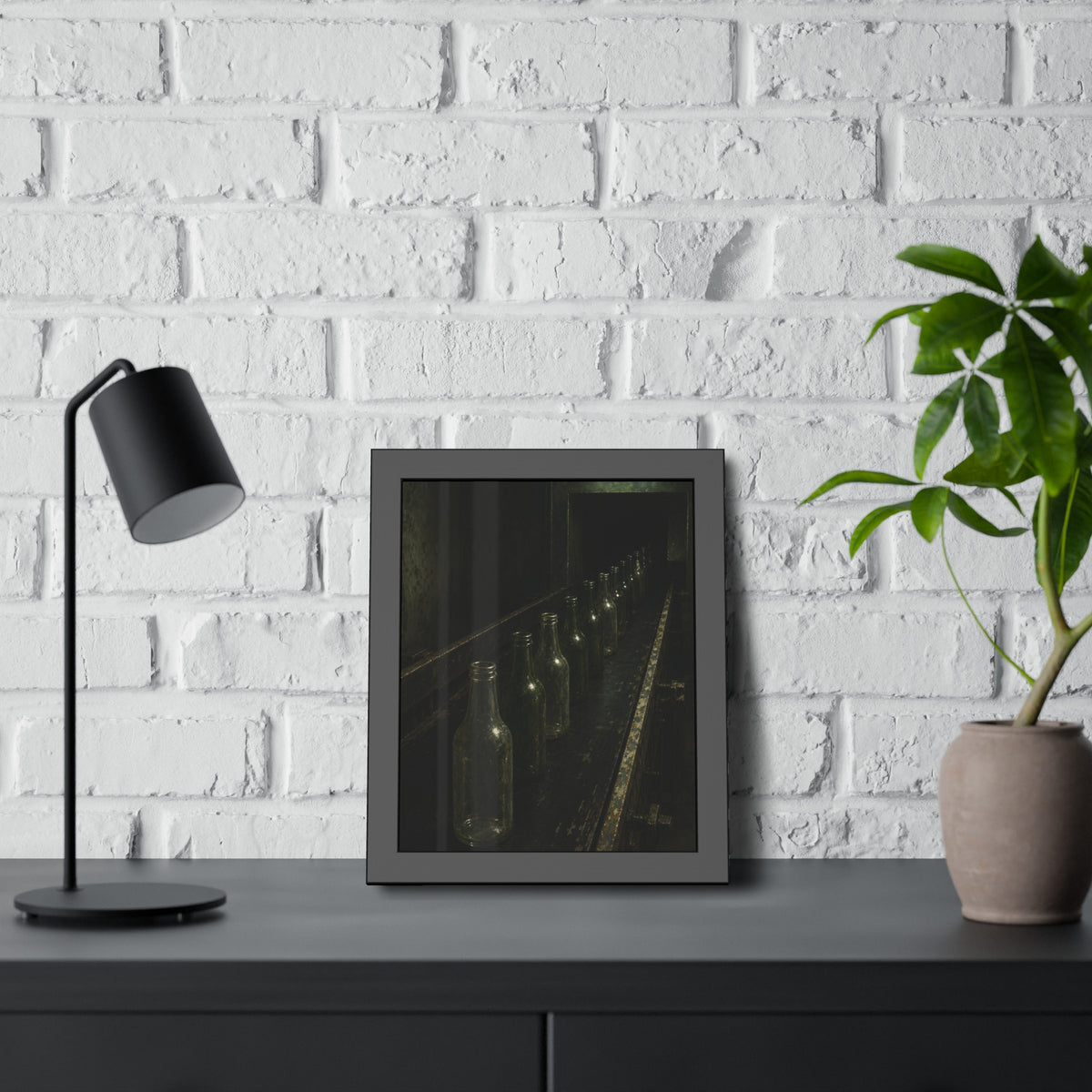 Empty glass bottles in a line on a conveyor under one fluorescent tube. The Procession of Bottles by Garabaggio, framed fine art print hanging in a room.