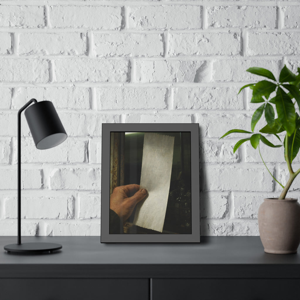 A hand holding a blank slip at a rusted counter window, bottles behind. The Receipt of Absolution by Garabaggio, framed fine art print hanging in a room.