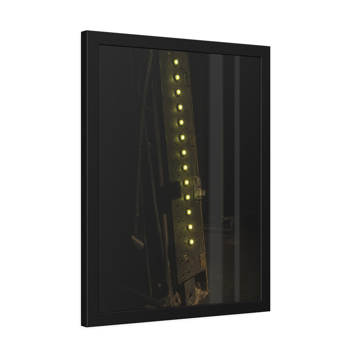 A dark rack panel with a vertical row of glowing green indicator lights. The First Green Choir by Garabaggio, framed fine art print hanging in a room.