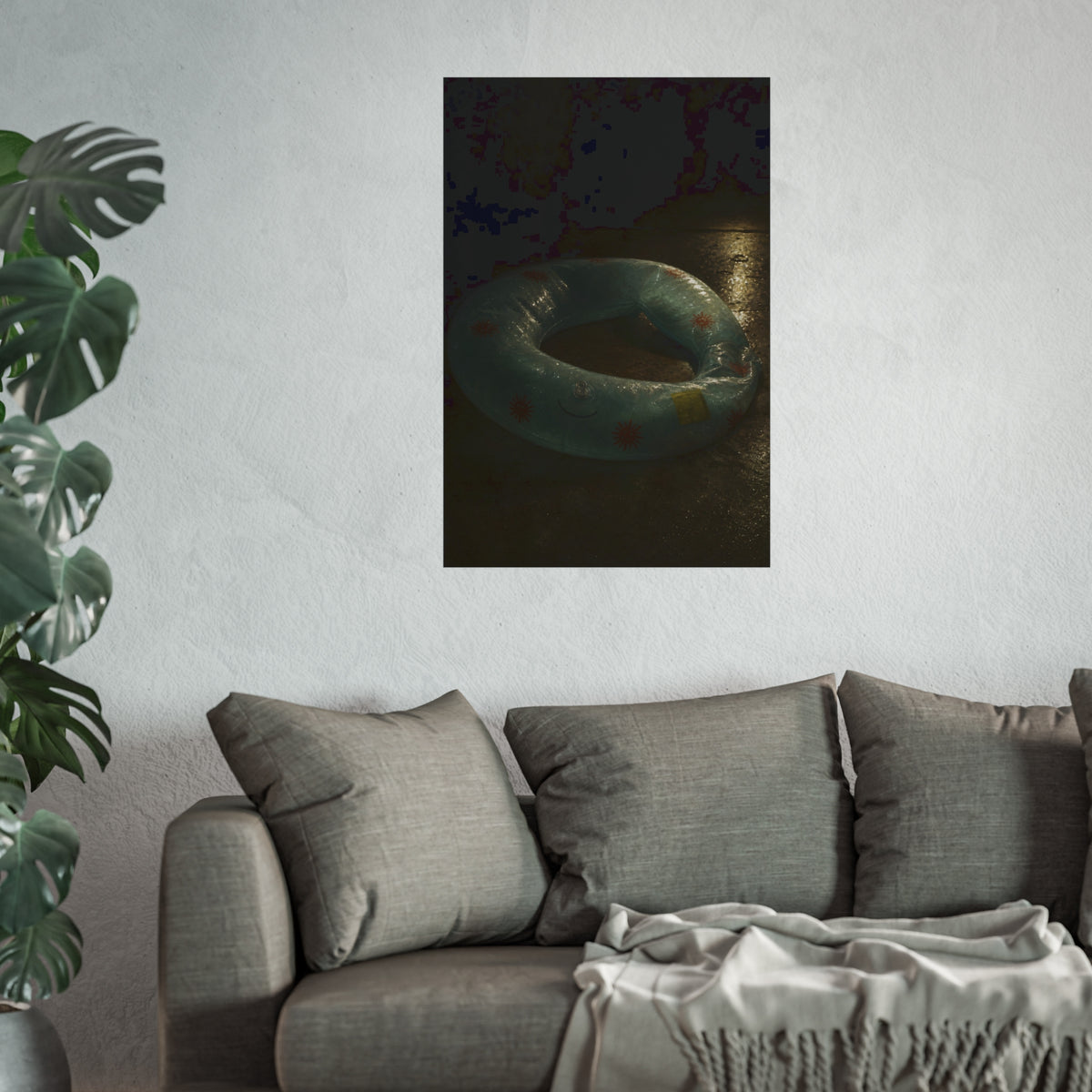 Deflated pool float ring on wet ground, lit from one side in the dark. After the Last Swim by Garabaggio, fine art print hanging in a room.