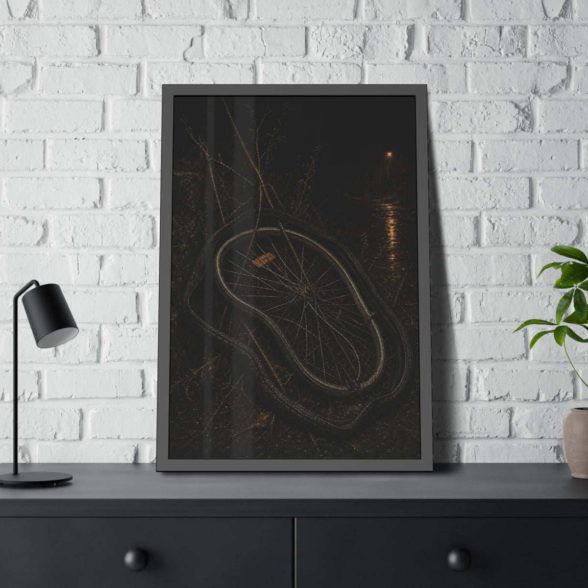 A bare bicycle wheel with its tire coiled around it on wet ground. The Removal of the Tire by Garabaggio, framed fine art print hanging in a room.