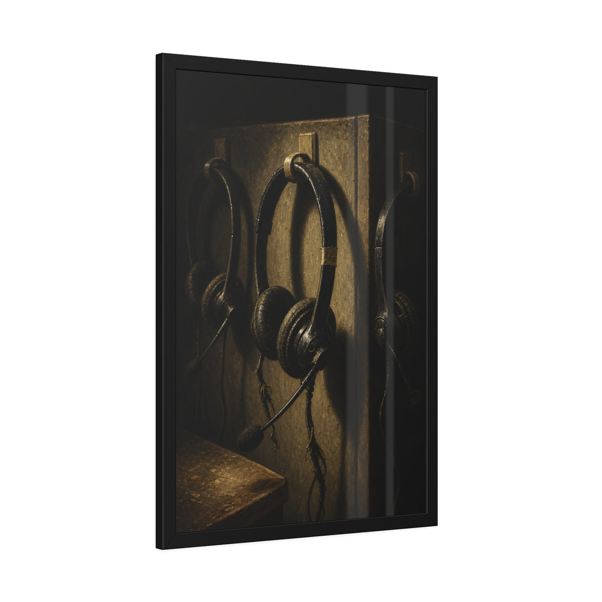 Three worn call center headsets hanging on wall hooks in dim light. The Headsets Left Hanging by Garabaggio, framed fine art print hanging in a room.