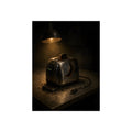 A scorched toaster under a work lamp, burnt toast standing in its slot. The Table of Examination by Garabaggio, fine art print, 12″ x 16″.
