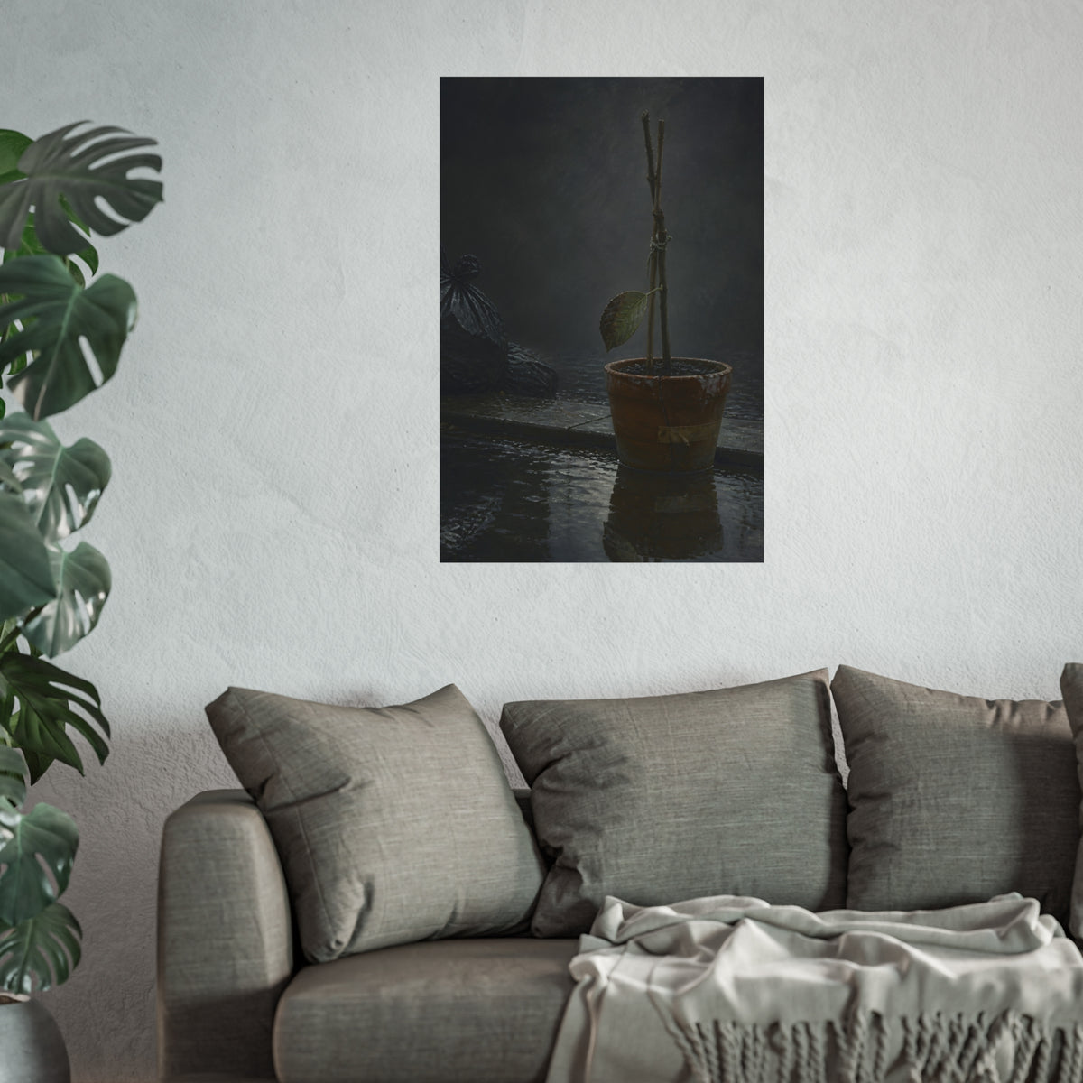 Bare tied stems in a clay pot on flooded pavement, one leaf remaining. The Grey Between by Garabaggio, fine art print hanging in a room.
