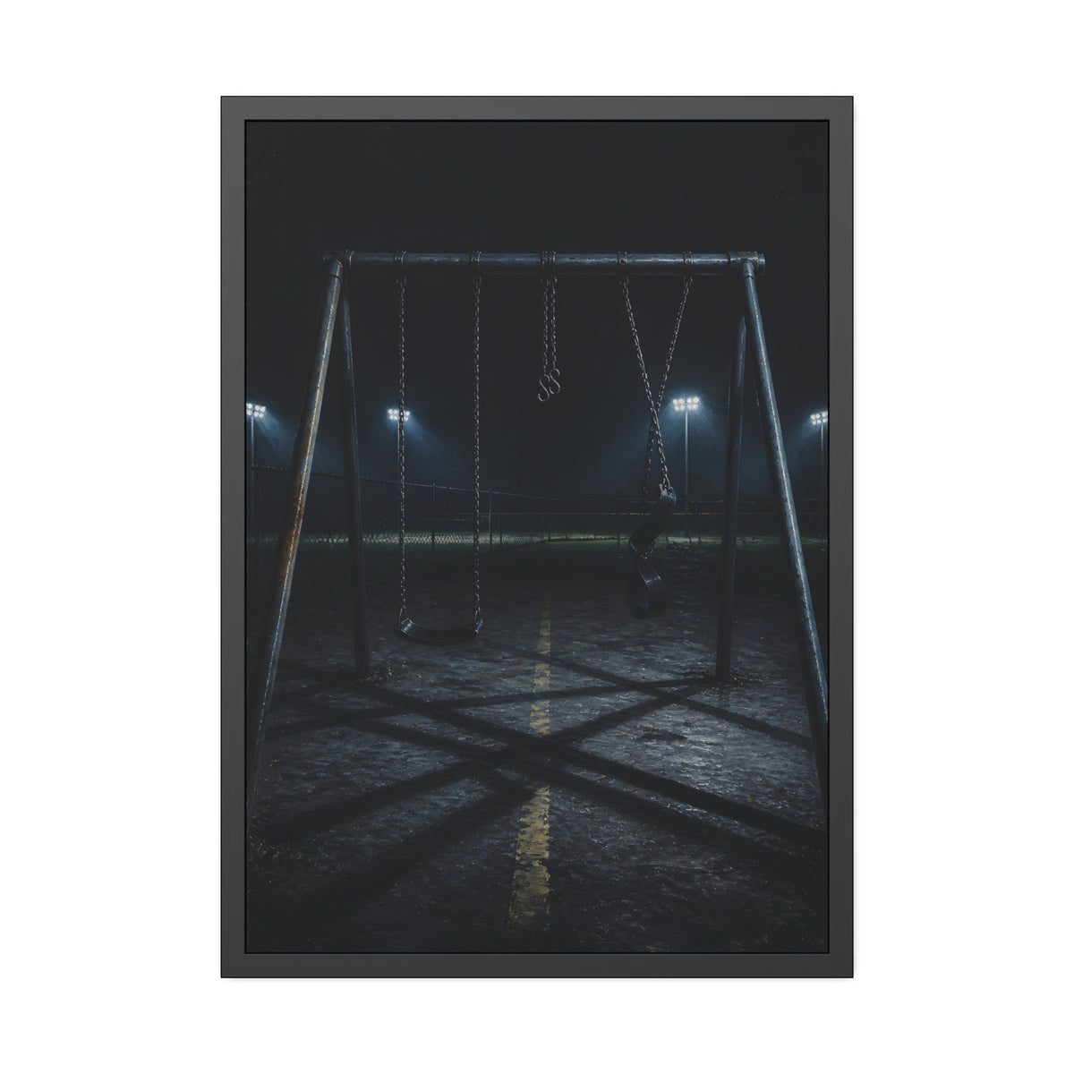 An empty swing set at night with field lights glowing behind it. The Ninth Hour: The Seat Still Moving by Garabaggio, framed fine art print, 28″ x 40″.