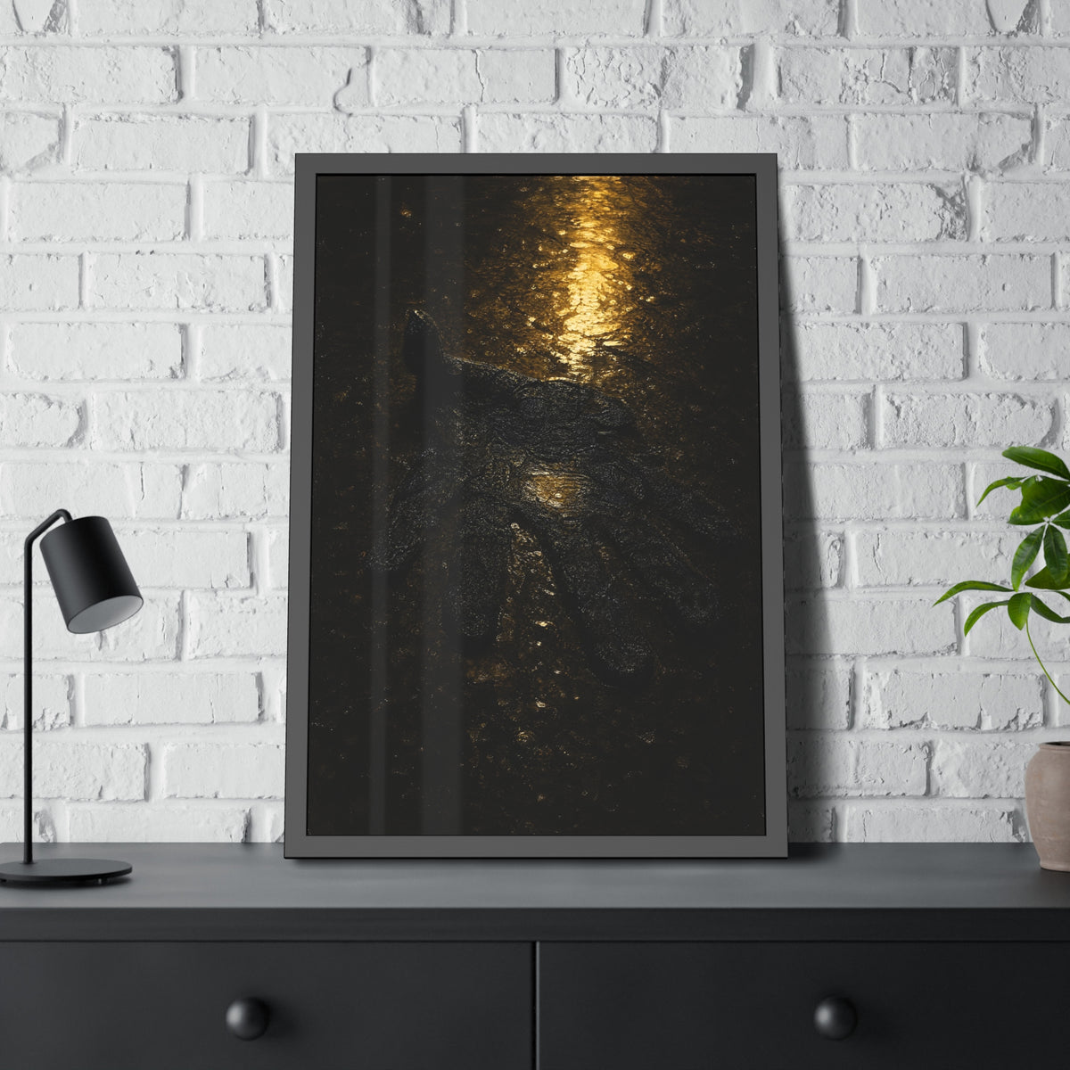 A flattened black glove pressed into wet asphalt beside a light streak. The Flattening, Study No. 1 by Garabaggio, framed fine art print hanging in a room.