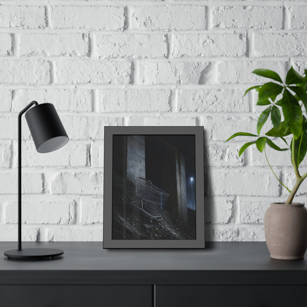 A shopping cart on a rocky slope under an overpass near a streetlamp. The Descent to the Underpass by Garabaggio, framed fine art print hanging in a room.