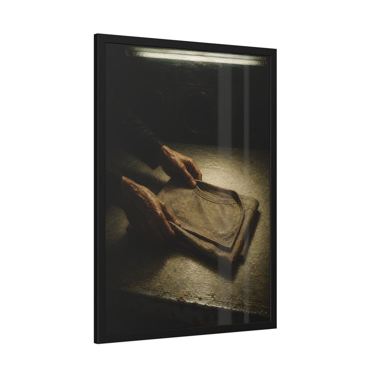 Two hands folding a shirt on a laundromat table with washers behind. The Folding at Two A.M by Garabaggio, framed fine art print hanging in a room.