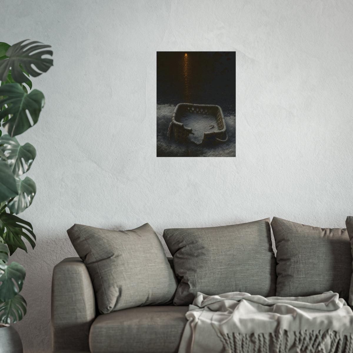 A cracked laundry basket half buried in snow under a distant lamp. The First Snow by Garabaggio, fine art print hanging in a room.