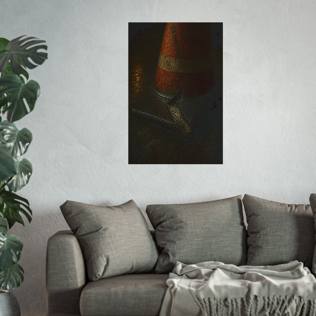 An orange traffic cone with a split base on wet asphalt at night. The Splitting of the Base by Garabaggio, fine art print hanging in a room.