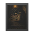 A laundry basket heaped with clothes on stairs under a bare bulb. The Overload on the Basement Stairs by Garabaggio, framed fine art print, 11″ x 14″.