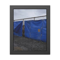 Blue tarps lashed to a chain link fence above gravel under grey sky. Drapery on the Fence by Garabaggio, framed fine art print, 11″ x 14″.