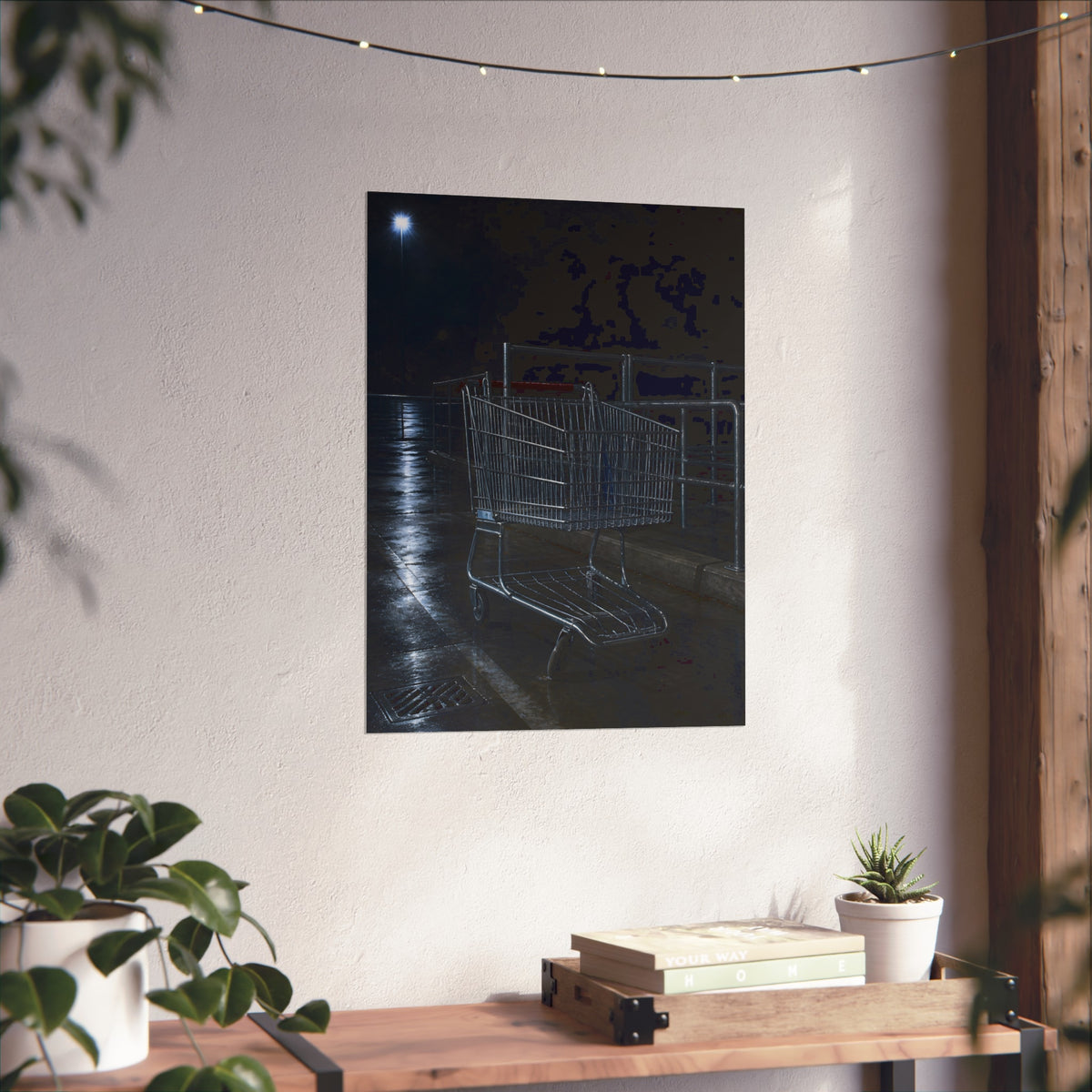 A shopping cart beside its corral on wet asphalt under a lot light. The Cart at the Corral by Garabaggio, fine art print hanging in a room.