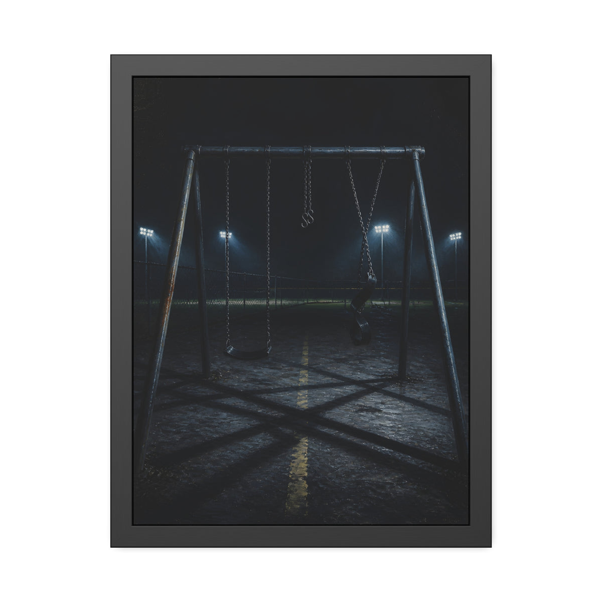 An empty swing set at night with field lights glowing behind it. The Ninth Hour: The Seat Still Moving by Garabaggio, framed fine art print, 18″ x 24″.