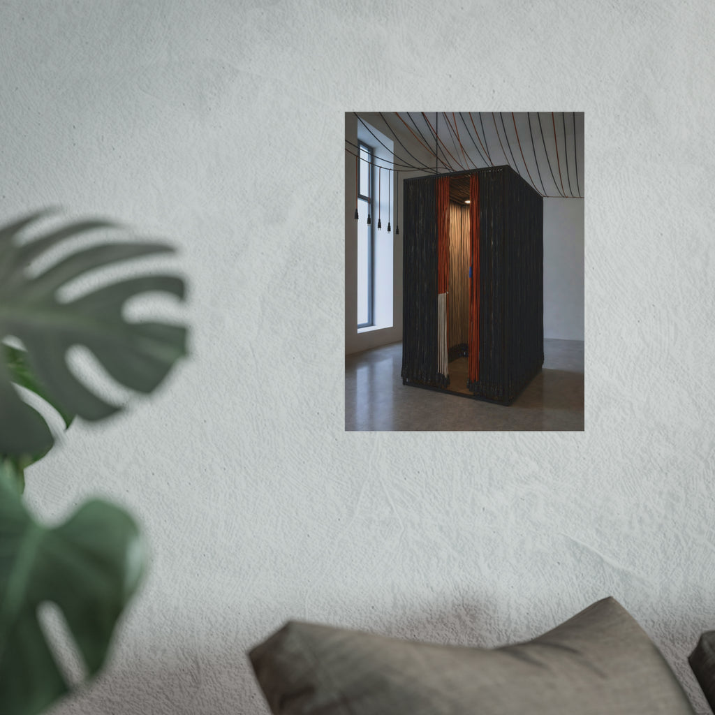 Booth walled with hanging power cords in a bare daylit room. Confessional for Current by Garabaggio, fine art print hanging in a room.