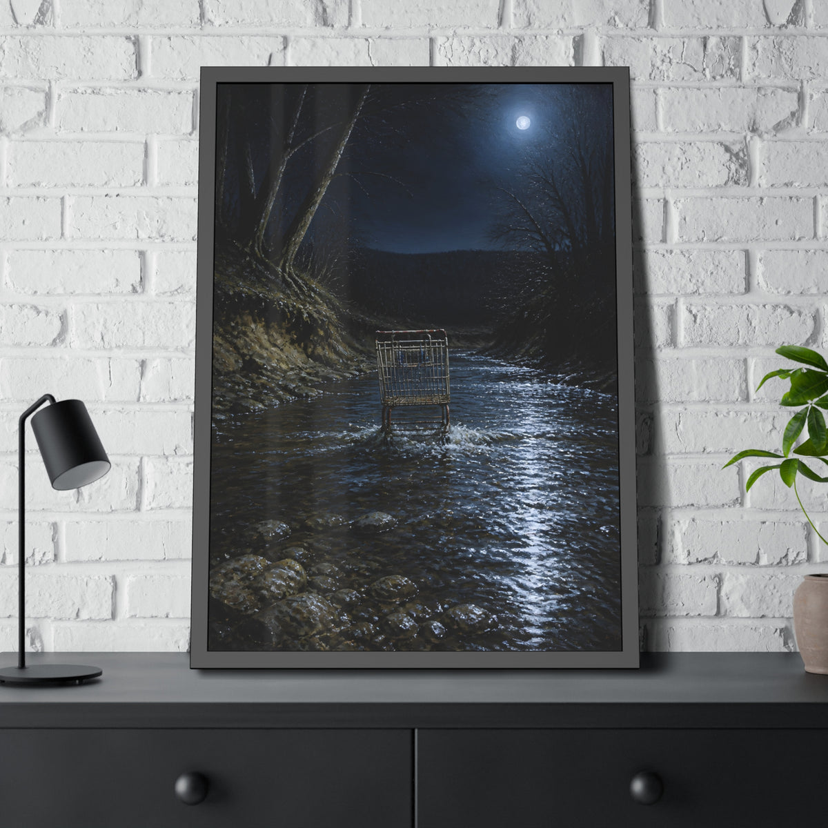 A shopping cart standing in a moonlit creek between dark trees. The Fording of the Creek by Garabaggio, framed fine art print hanging in a room.