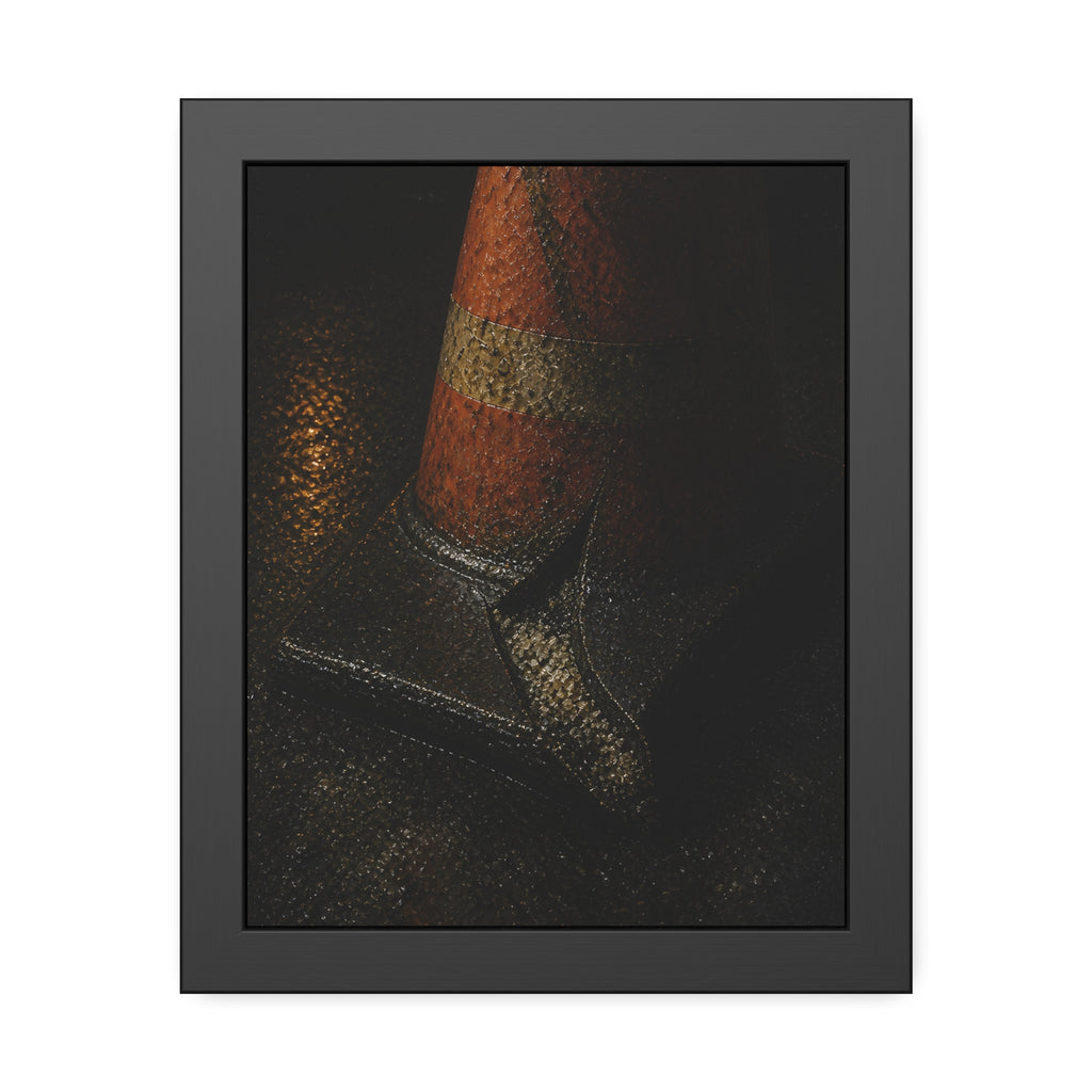 An orange traffic cone with a split base on wet asphalt at night. The Splitting of the Base by Garabaggio, framed fine art print, 11″ x 14″.