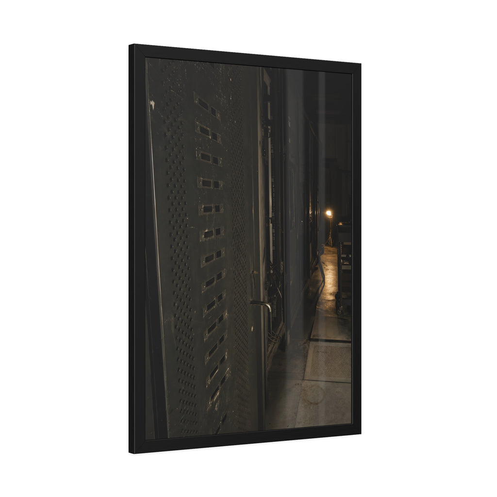 Rows of dark server cabinets with one work lamp glowing far down the aisle. Racks Without Light by Garabaggio, framed fine art print hanging in a room.