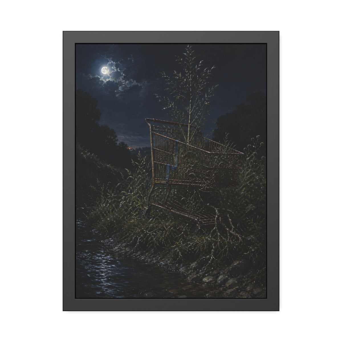 A shopping cart in creekside weeds with a sapling growing up through it. The Cart Grown Through by Garabaggio, framed fine art print, 18″ x 24″.