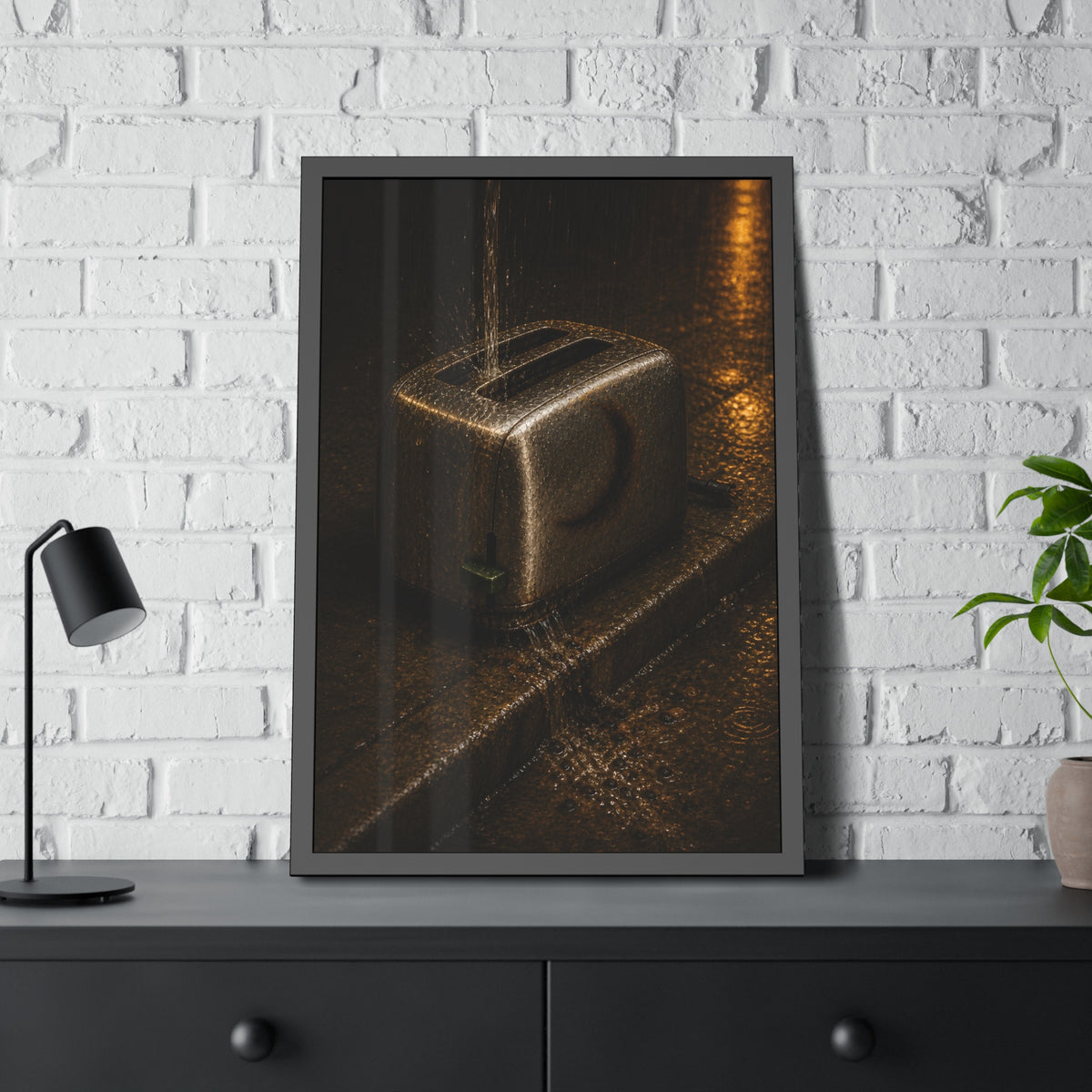 A toaster on a wet curb with water pouring into its slots. Rain Through the Slots by Garabaggio, framed fine art print hanging in a room.