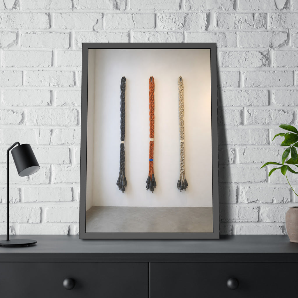 Three braided bundles of extension cords hung on a white gallery wall. The Braided Triptych by Garabaggio, framed fine art print hanging in a room.