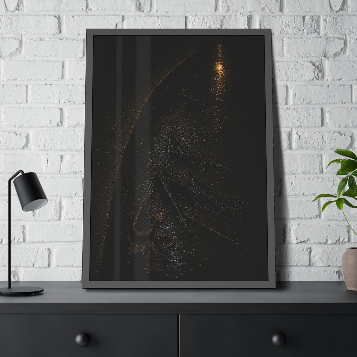 A collapsed umbrella in a dark wet gutter beside a curb, one distant light. The Procession in the Gutter by Garabaggio, framed fine art print hanging in a room.