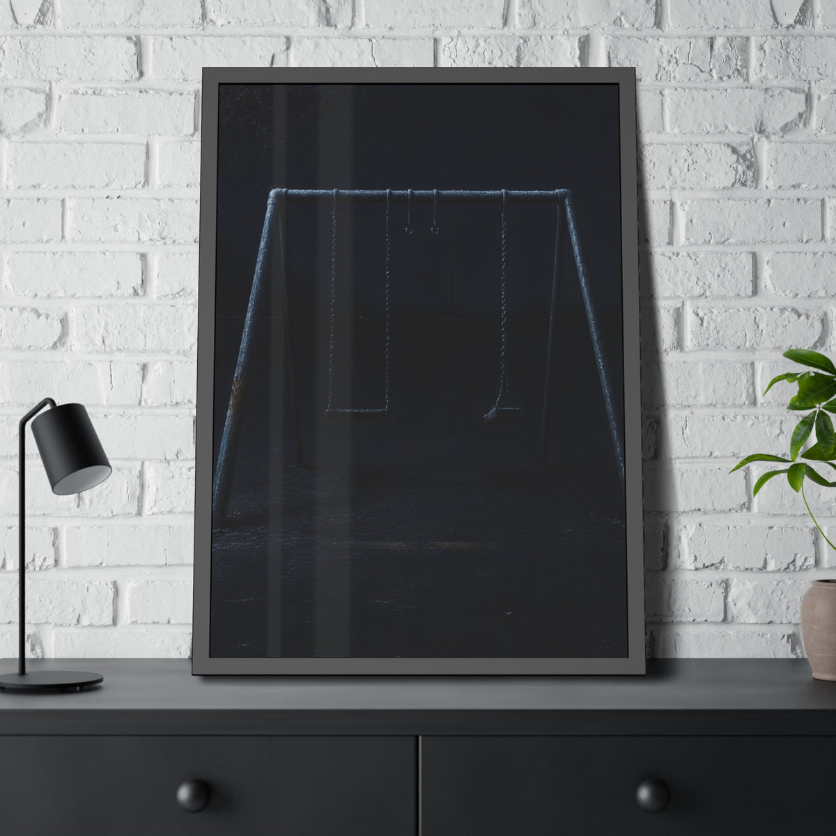 An empty swing set in near darkness with one seat twisted. The Fourth Hour: The Floodlights Cut by Garabaggio, framed fine art print hanging in a room.