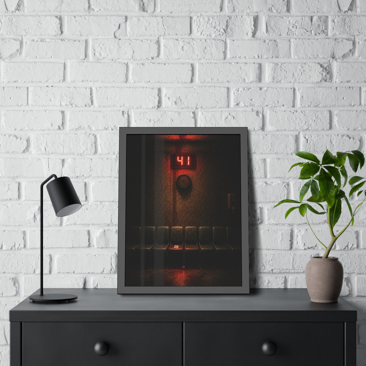 An empty row of waiting room seats beneath a red display reading 41. The Call That Does Not Come by Garabaggio, framed fine art print hanging in a room.
