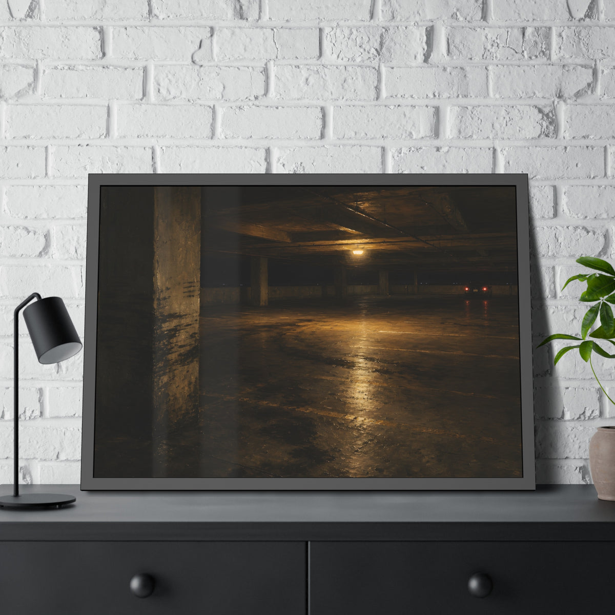 An empty concrete parking deck lit by one ceiling lamp, tail lights beyond. The Parking Garage, Level 4 by Garabaggio, framed fine art print hanging in a room.