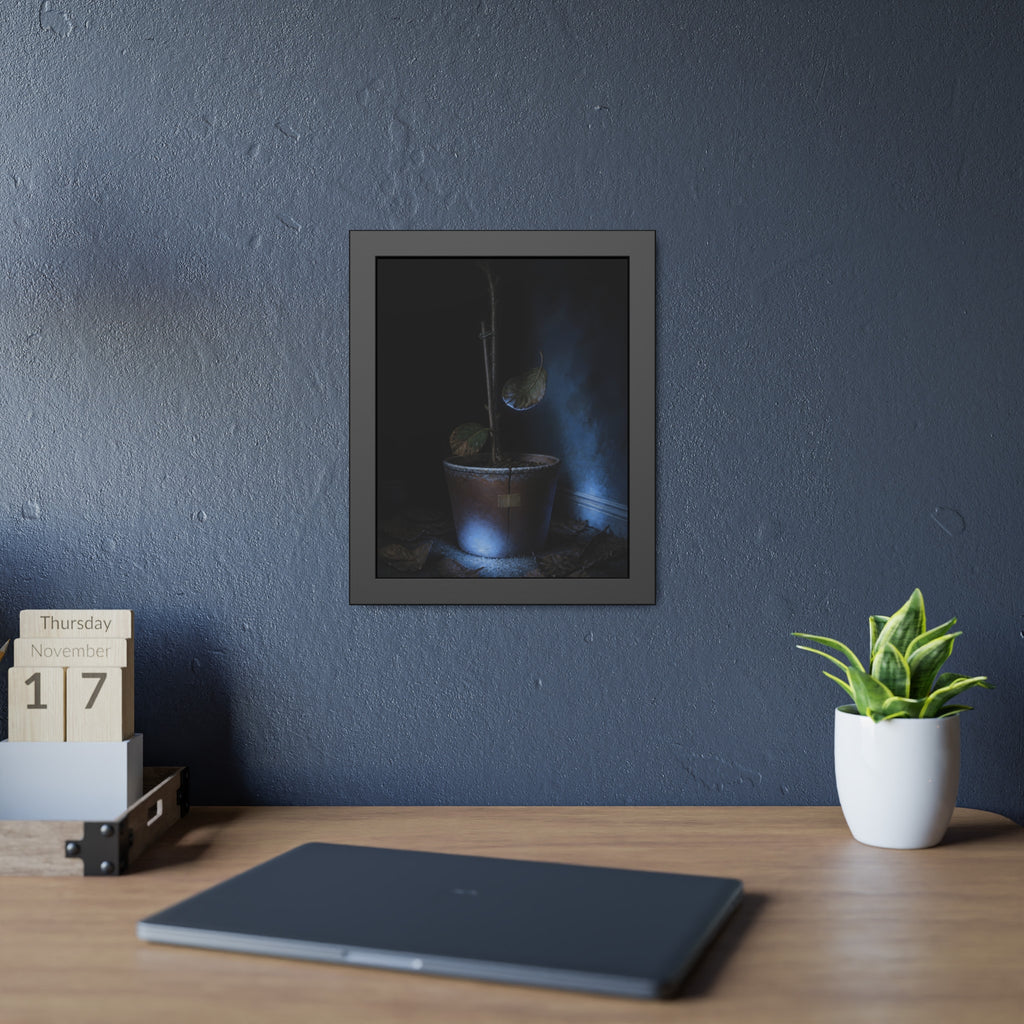 A bare potted plant dropping a leaf, dead leaves on the floor. The Leaf Lets Go by Garabaggio, framed fine art print hanging in a room.