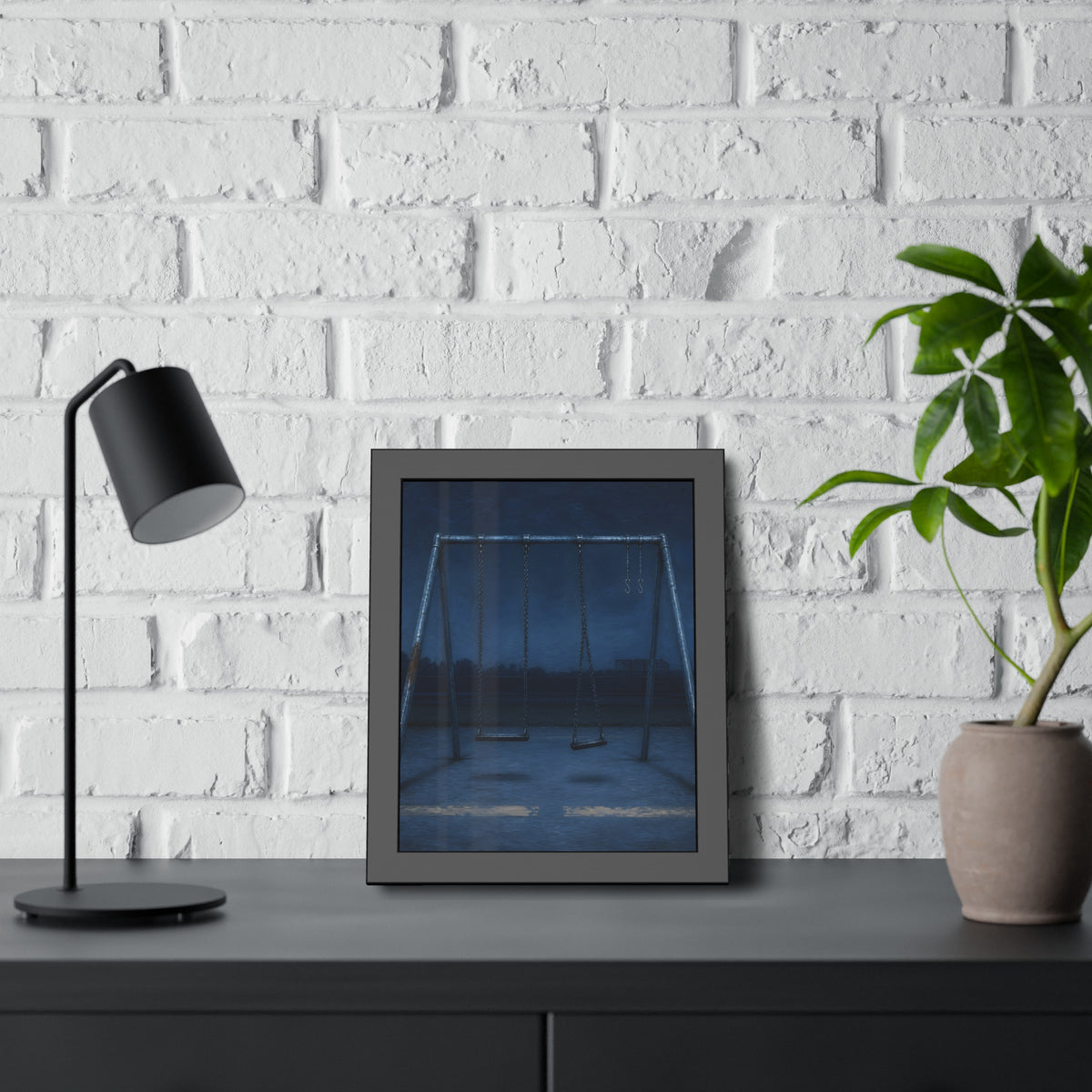 A swing set with two seats and two bare hooks in blue predawn light. The Fifth Hour: The Blue Before by Garabaggio, framed fine art print hanging in a room.