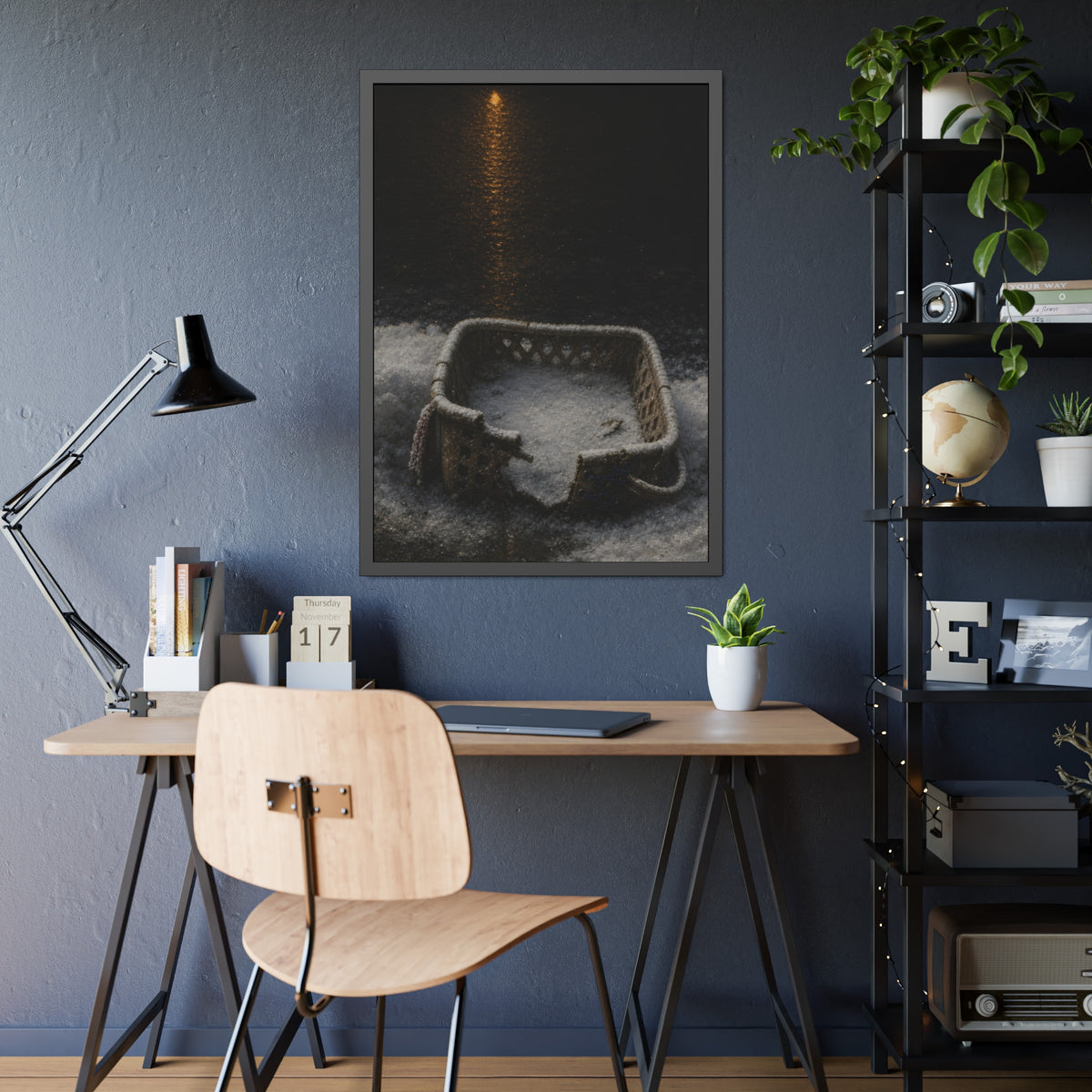 A cracked laundry basket half buried in snow under a distant lamp. The First Snow by Garabaggio, framed fine art print hanging in a room.
