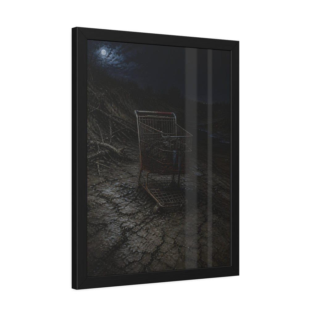 A rusted shopping cart sunk in cracked dried mud under a full moon. The Silting by Garabaggio, framed fine art print hanging in a room.